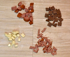 Ideal soft dog training treats, clockwise from upper left: hot dogs, Happy Howie's food roll, kielbasa, cheese. All are cut into pea-sized pieces.